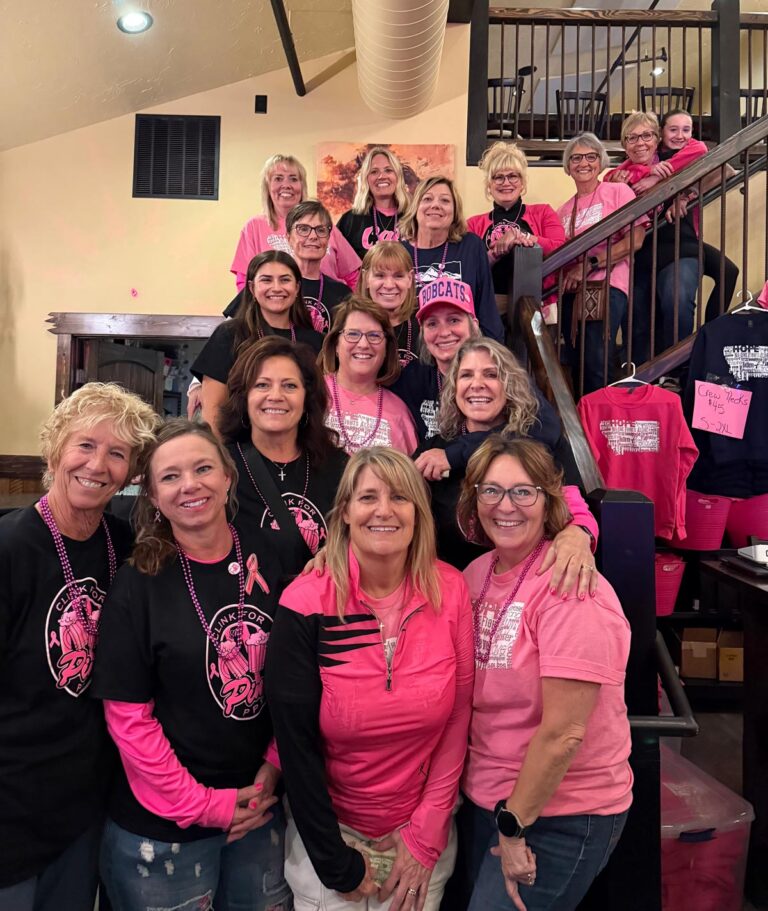 A group photo of the Pack the Place in Pink team