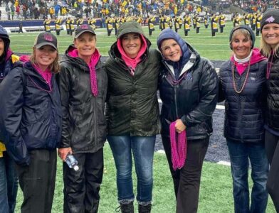 Group of women standing on a football field