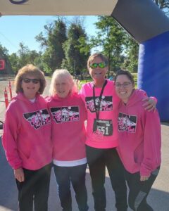 Group of four women in pink sweatshirts