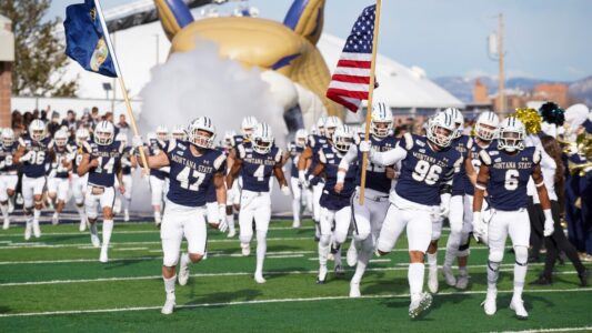 Bobcat Football Players running up the field