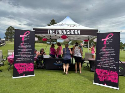 Lake Hills Golf Course booth with Pack the Place in Pink feature